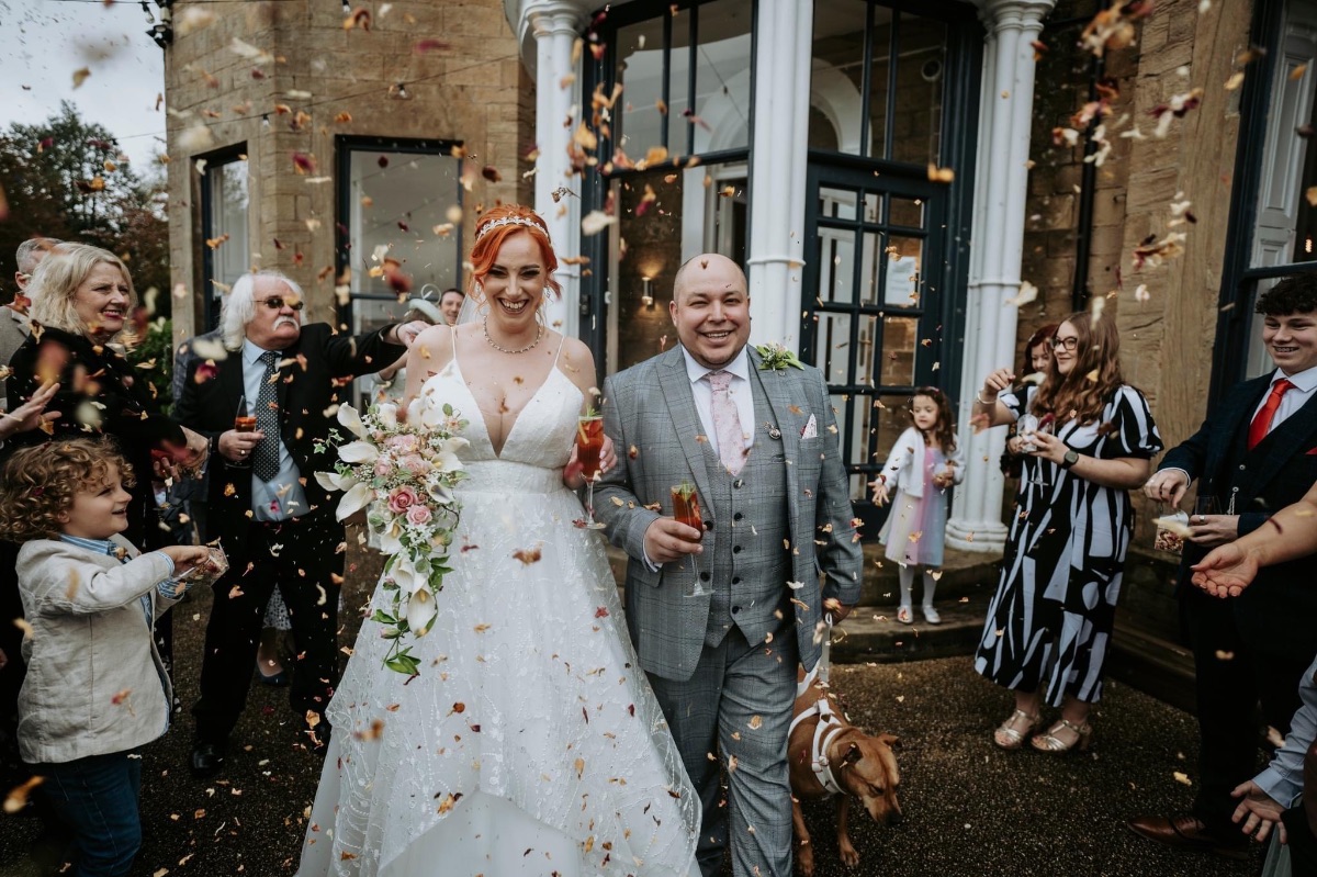 Jennifer & Dave exit Carr bank with confetti thrown by guests at Carr Bank Wedding Venue Mansfield Nottinghamshire