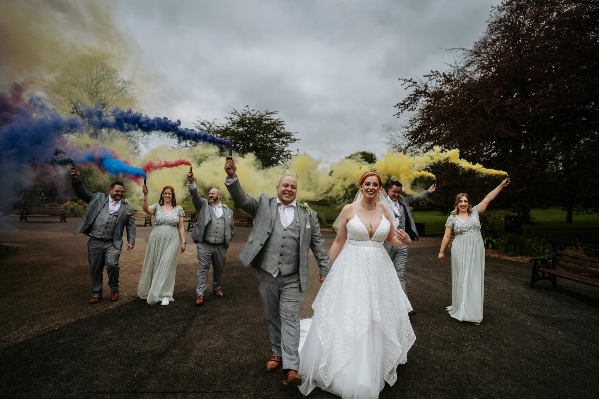 Jennifer & Dave holding smoke flares to create a wonderful photo at Carr Bank Wedding Venue Mansfield Nottinghamshire