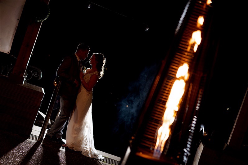 Lucy & Jordan pose for a picture at dusk, lit by our outdoor heaters at Carr Bank Wedding Venue Mansfield Nottinghamshire 