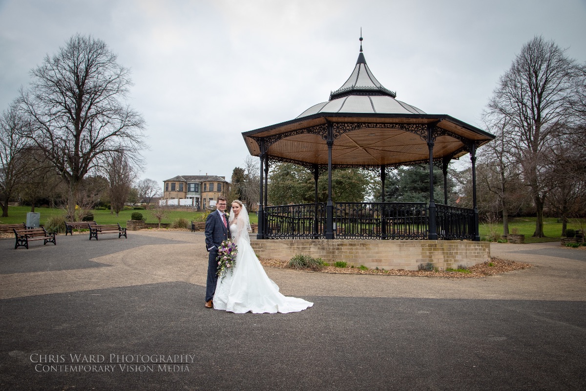 Laura & Dan pose in front of the Bandstand on Carr Bank Park at Carr Bank Wedding Venue Mansfield Nottinghamshire 