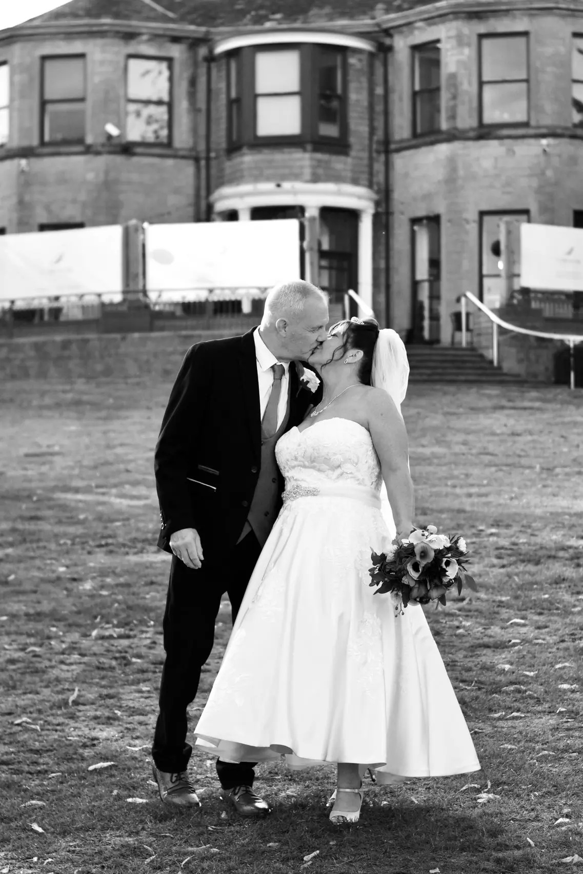Nicola & mark sharing a kiss in the Carr Bank grounds at Carr Bank Wedding Venue Mansfield Nottinghamshire 