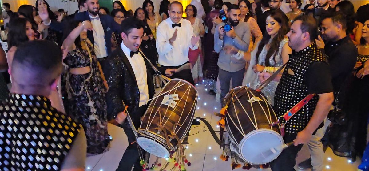 Groom joins in with the Dhol players