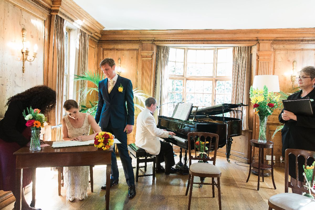 The happy couple signing the register.