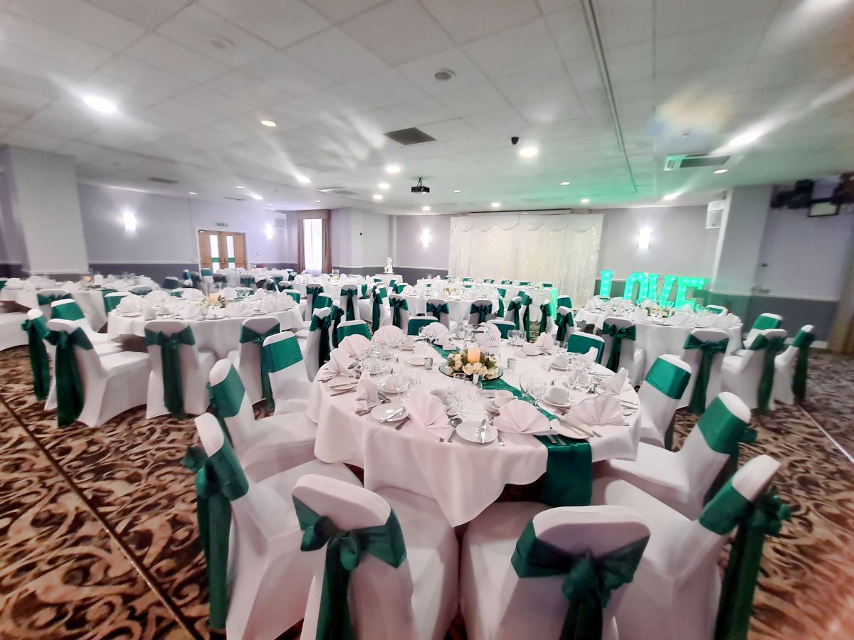 Chair covers with green sashes, Twinkle backdrop, centrepieces & stationery Light up letters venues own
