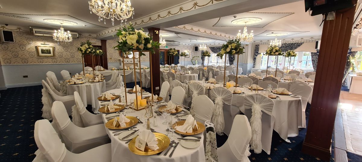 Wedding breakfast Set up With chair covers & waterfall ruffles, geometric stand centrepieces & Charger Plates