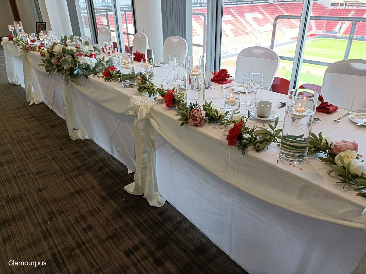 Top Table flowers, garlands and cylinder vases with swag