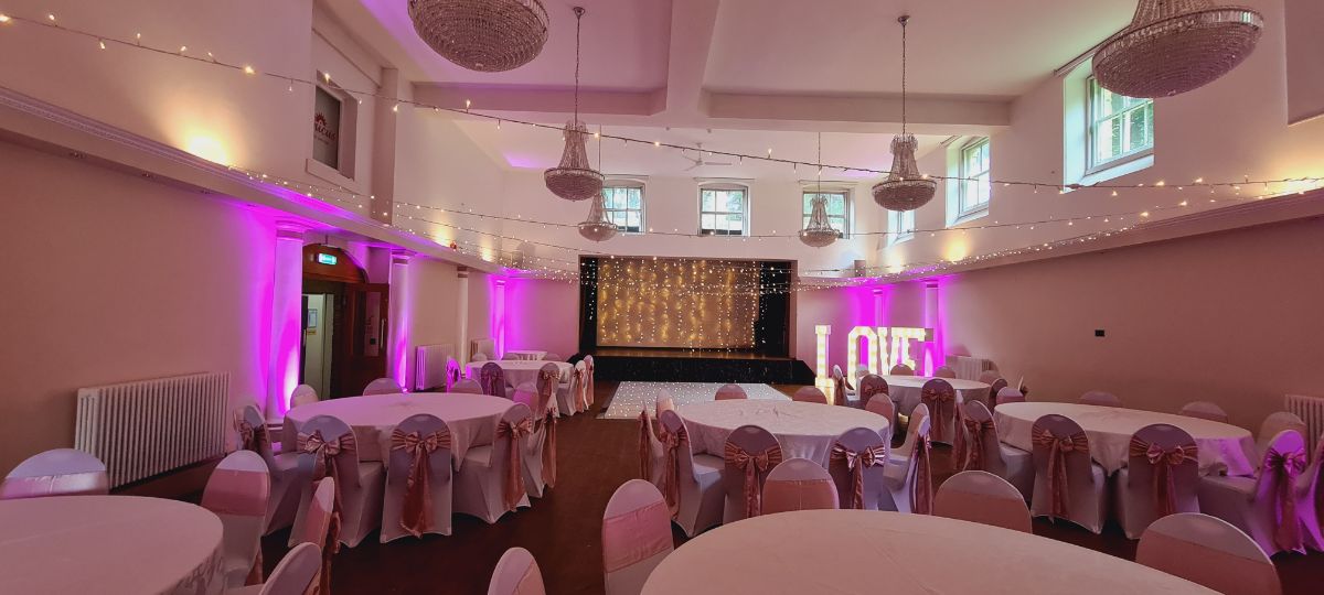 Evening room set up, with fairy light curtain, uplighting and light up love 