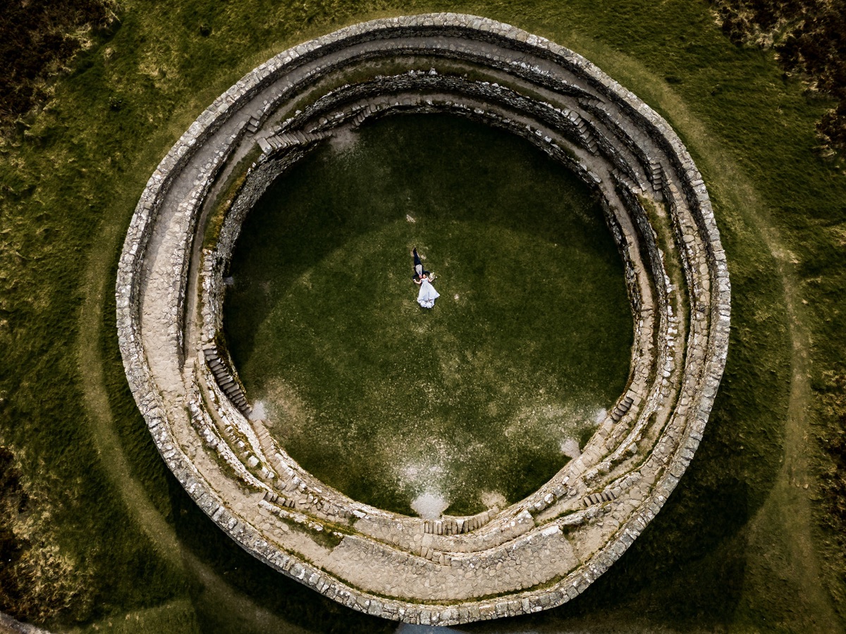 Aerial drone photograph of the bride and groom at An Grianan of Aileach fort in county Donegal.