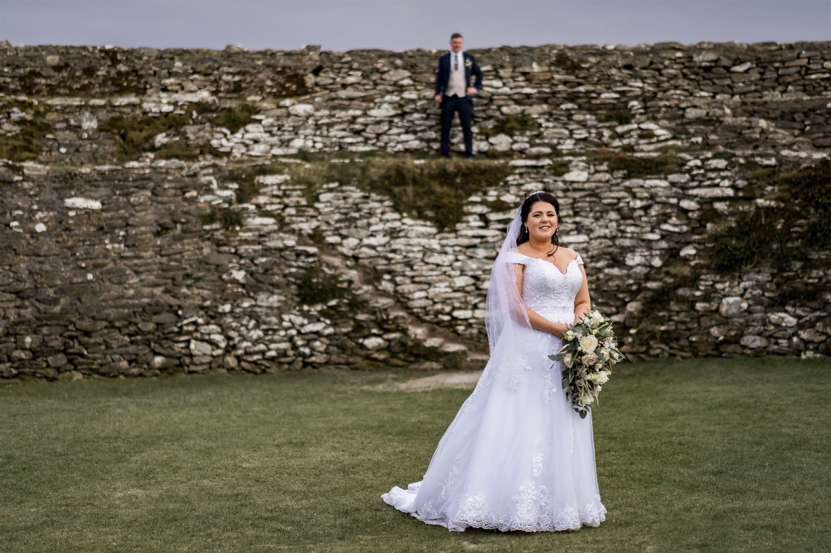 bridal portrait with groom in background