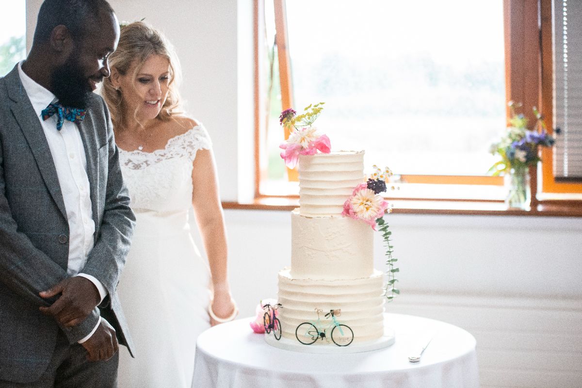 The couple admiring their wedding cake