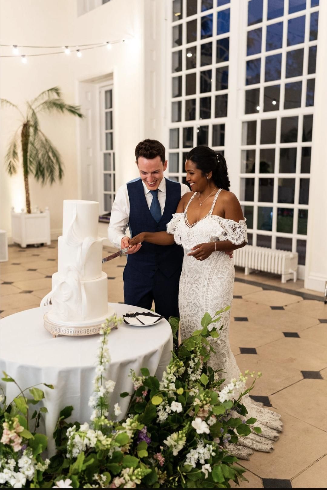 The couple cutting their wedding cake