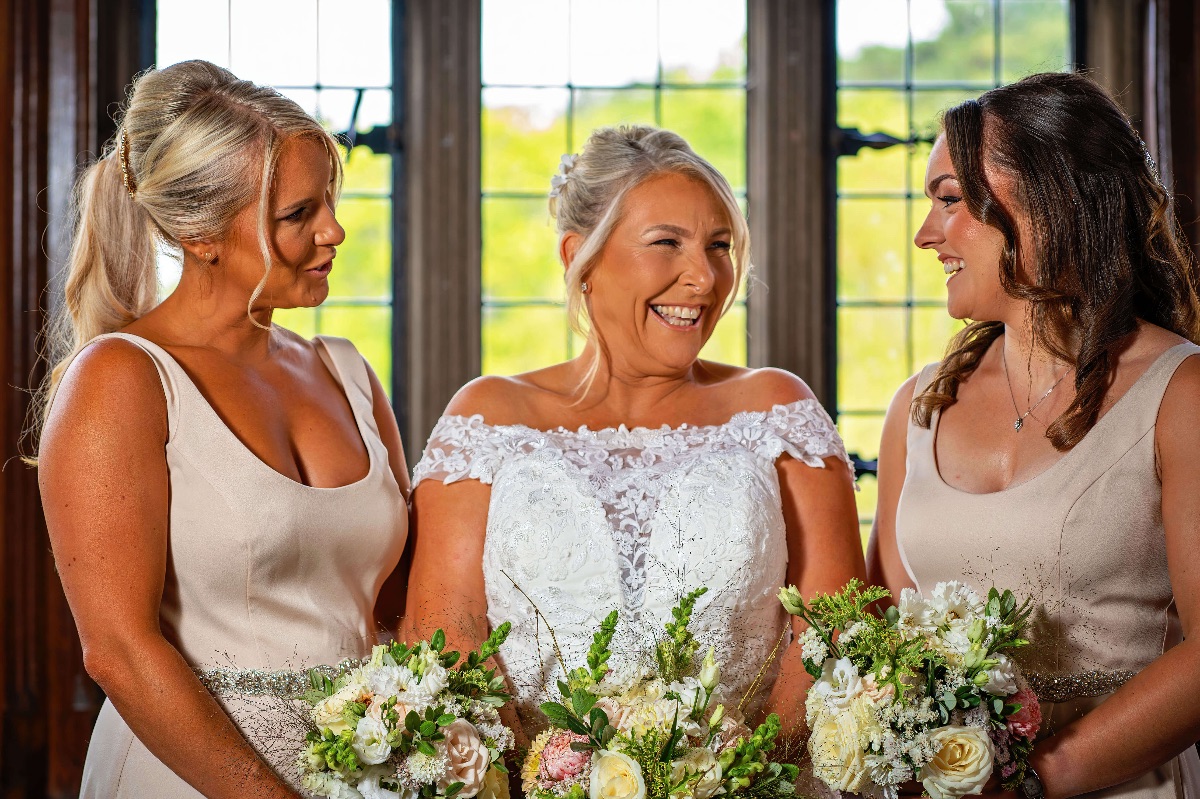 The bride and her bridesmaid have a chat before the ceremony begins at Fanhams Hall