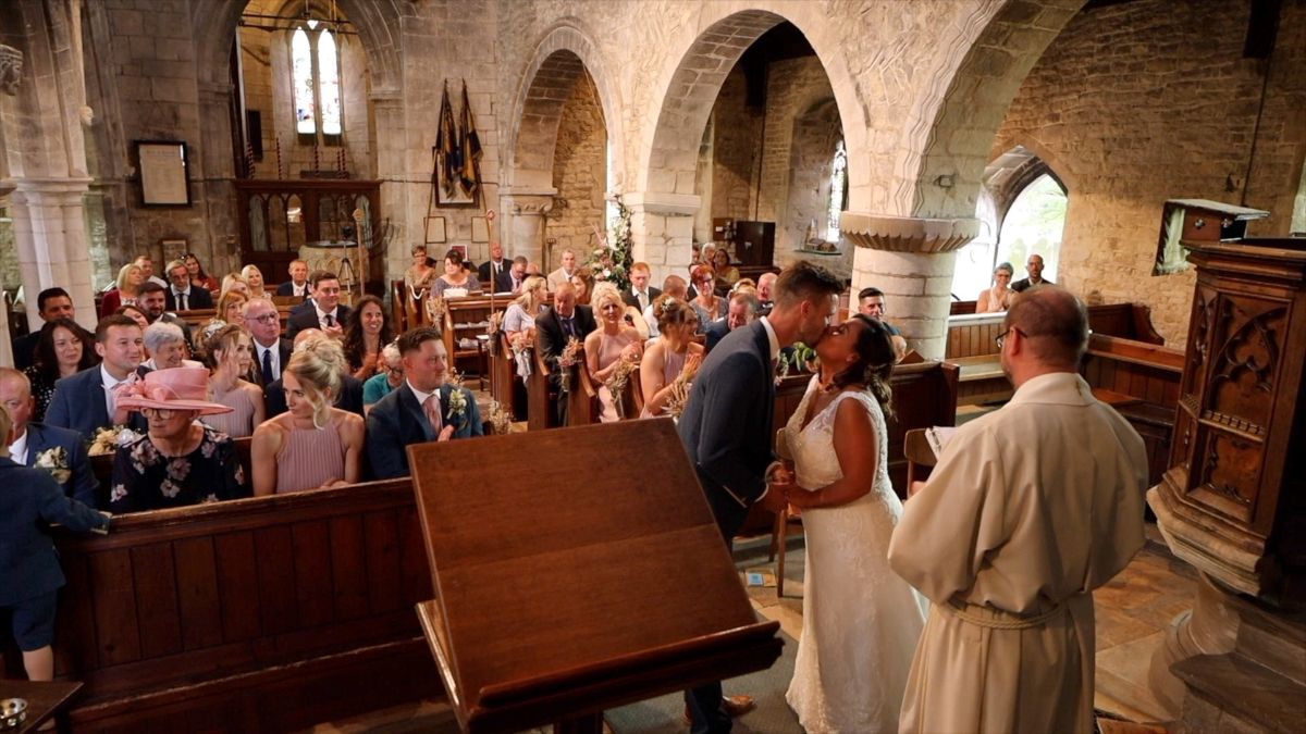 The bride and groom share their first married kiss