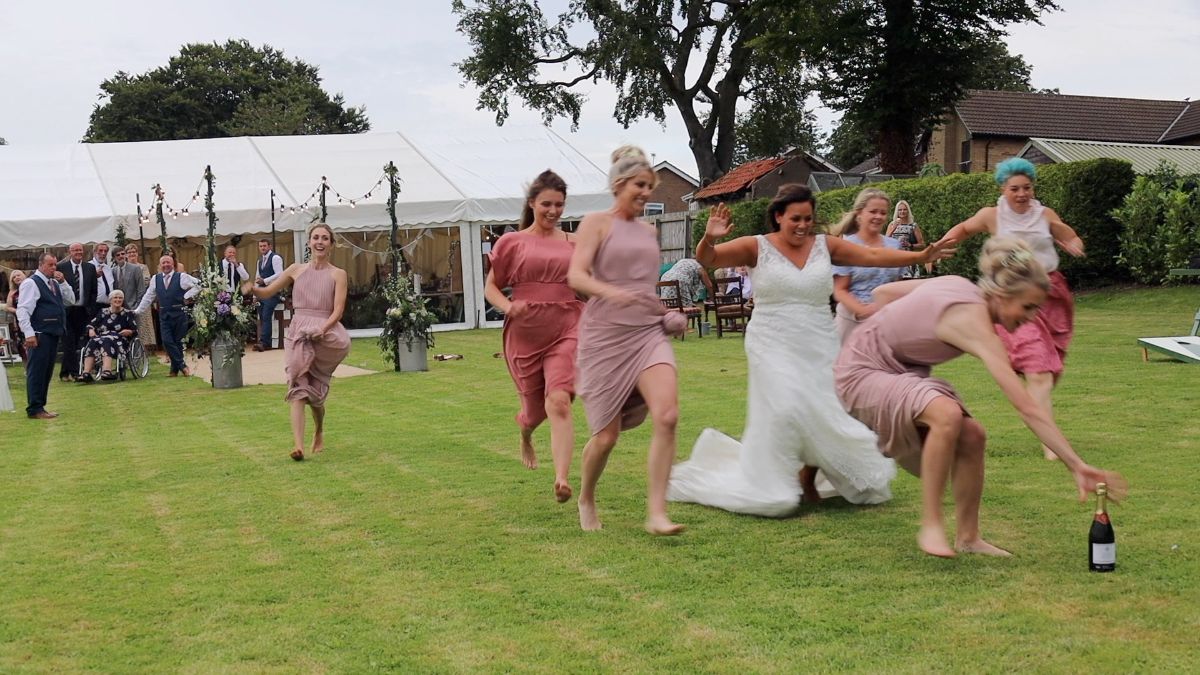 The bridal party run for the Prosecco