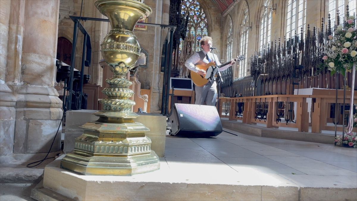 Curly serenades the bride and groom as they sign the register 