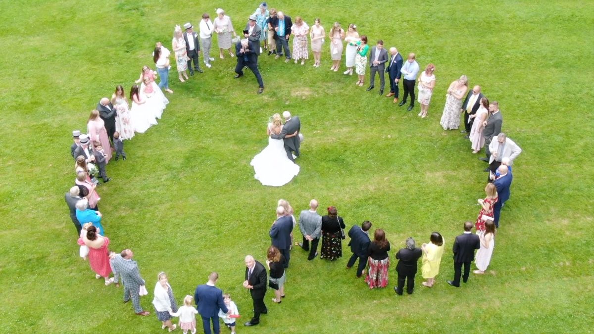 The wedding party show their love for the bride and groom from the air