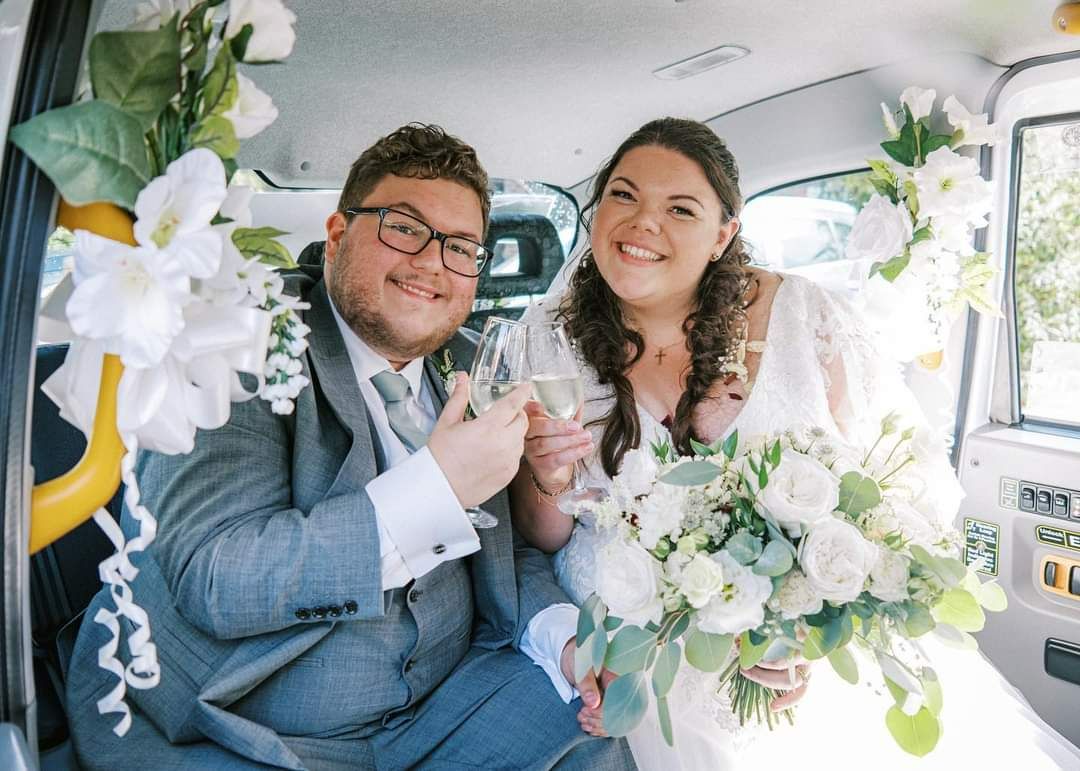 The couple in the car before travelling to the reception