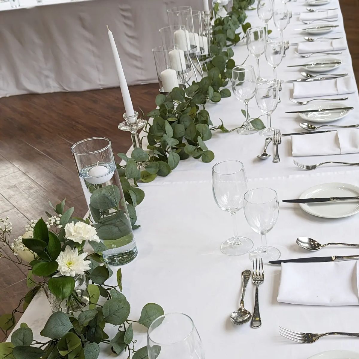Greenery, glass vases and candle sticks 