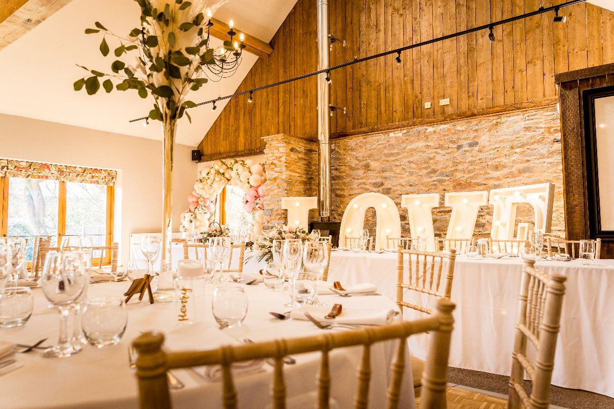 The beautiful Reception Room with rustic chairs, LOVE Letters & blush pinks and sage...