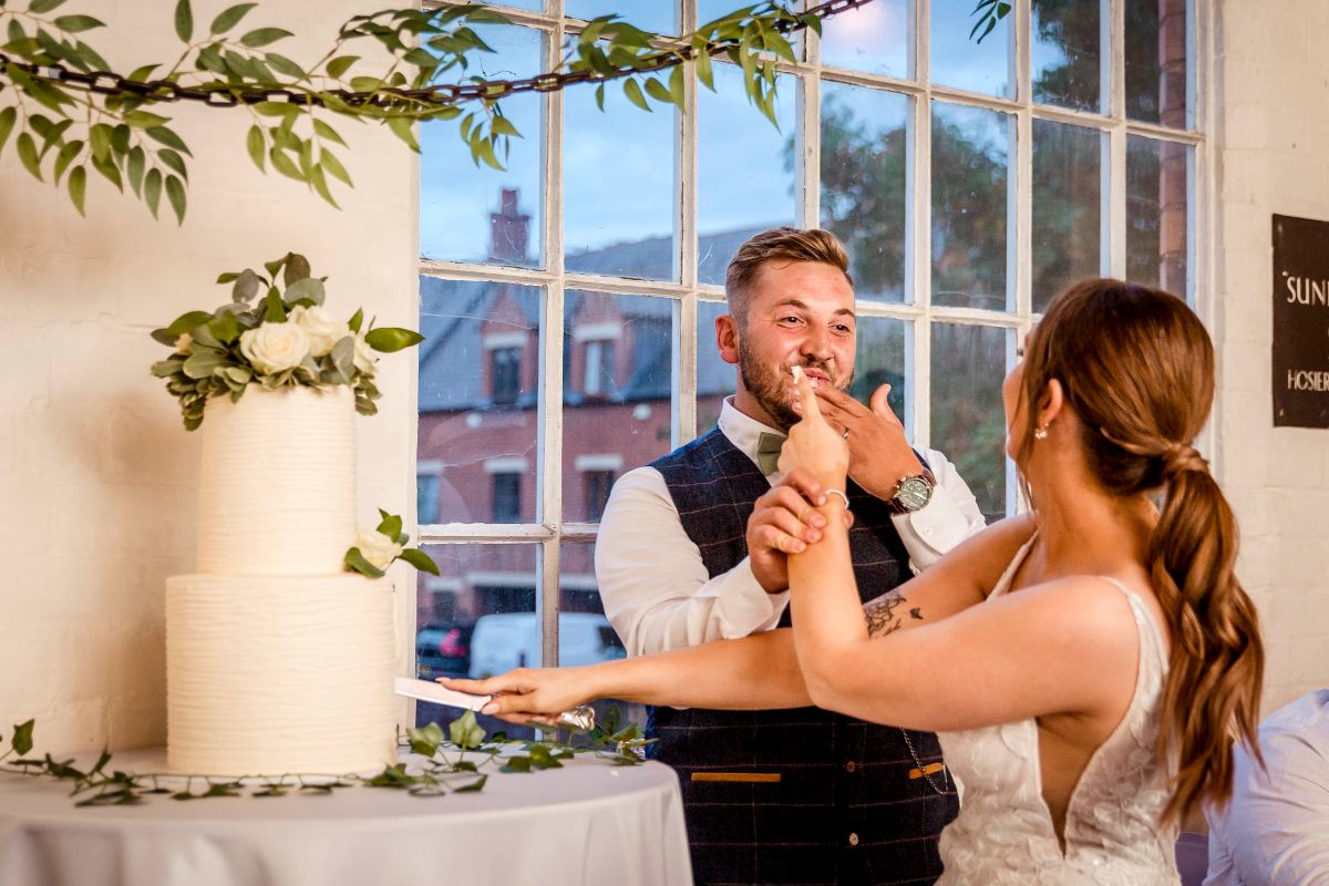 The playful Groom and his new Wife cut the cake at The Factory Hinckley