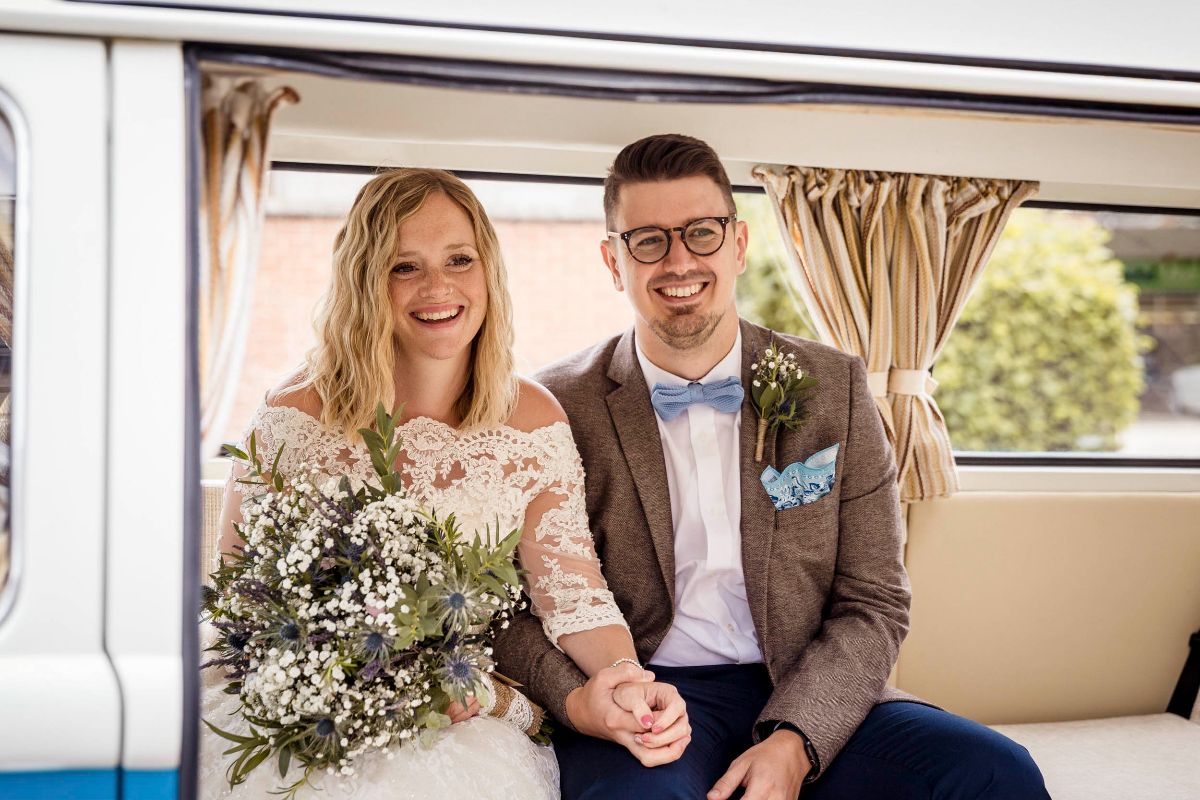 Bride & Groom smiling in Vintage VW Camper Van, Market Harborough