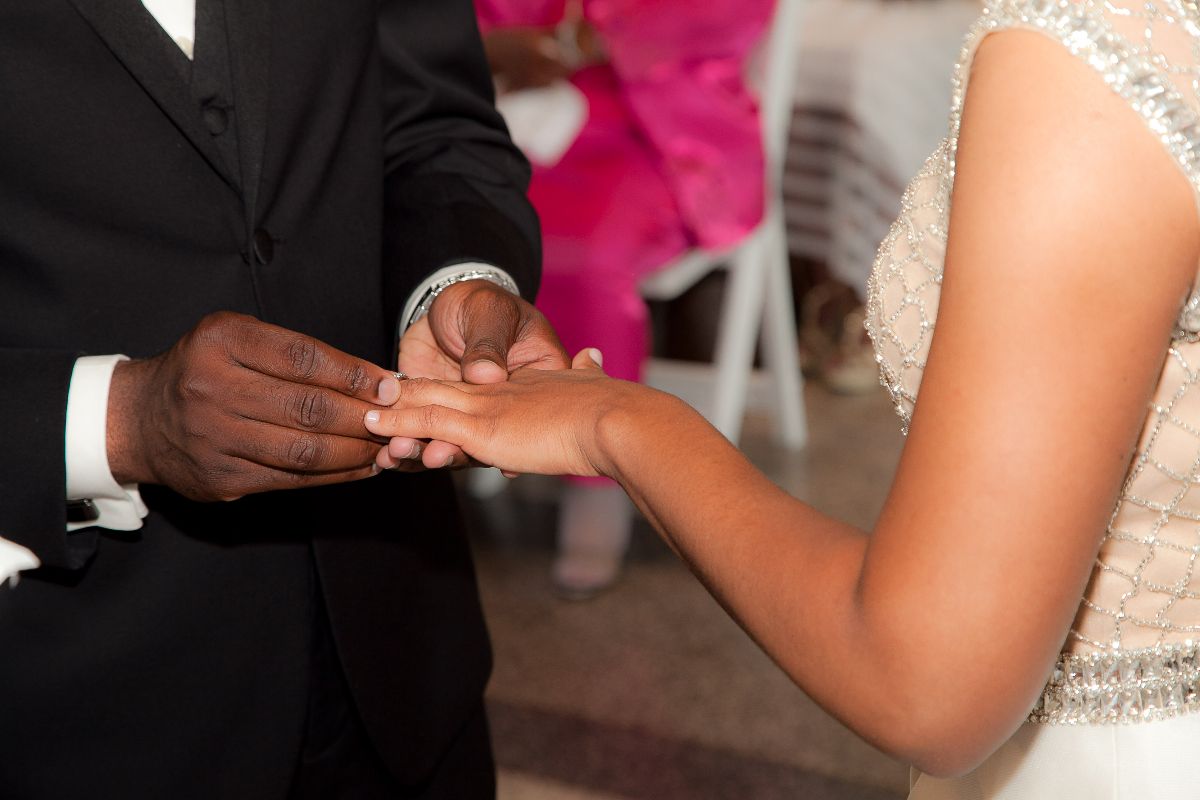 On goes the bride's ring to seal the commitment.