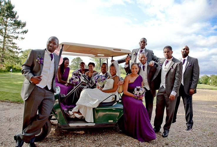 A portrait of the bridal party in the golf cart. 