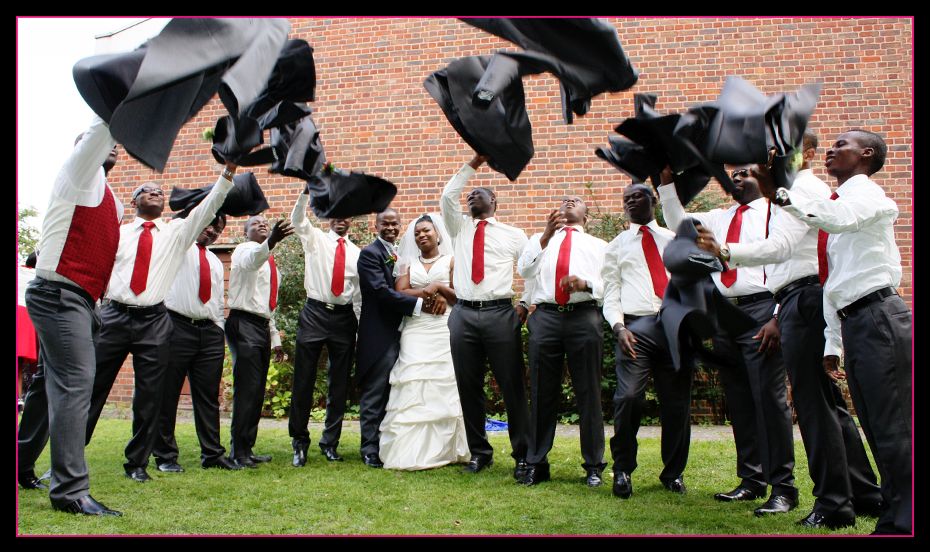 The Nigerian Groomsmen throwing their jackets in the air.