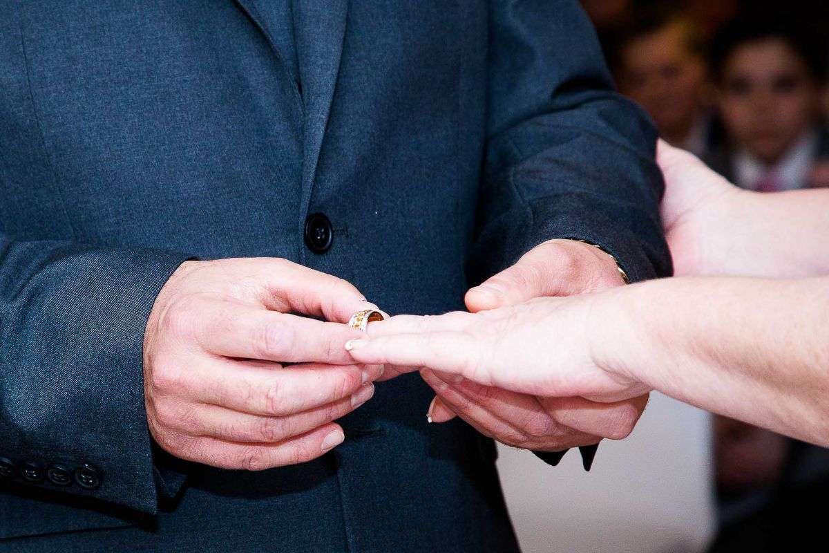 The Bridegroom puts the ring on his Bride