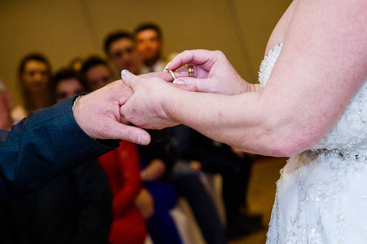 The Bride is putting the ring on her future husband