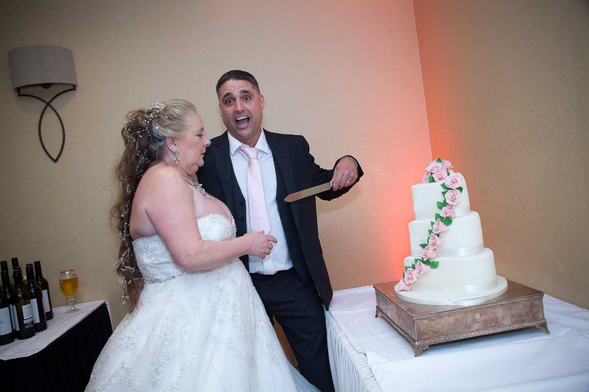 Bride and groom preparing to cut the cake
