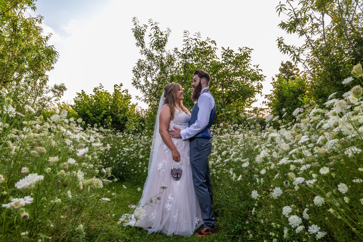 The happy couple in the wildflowers