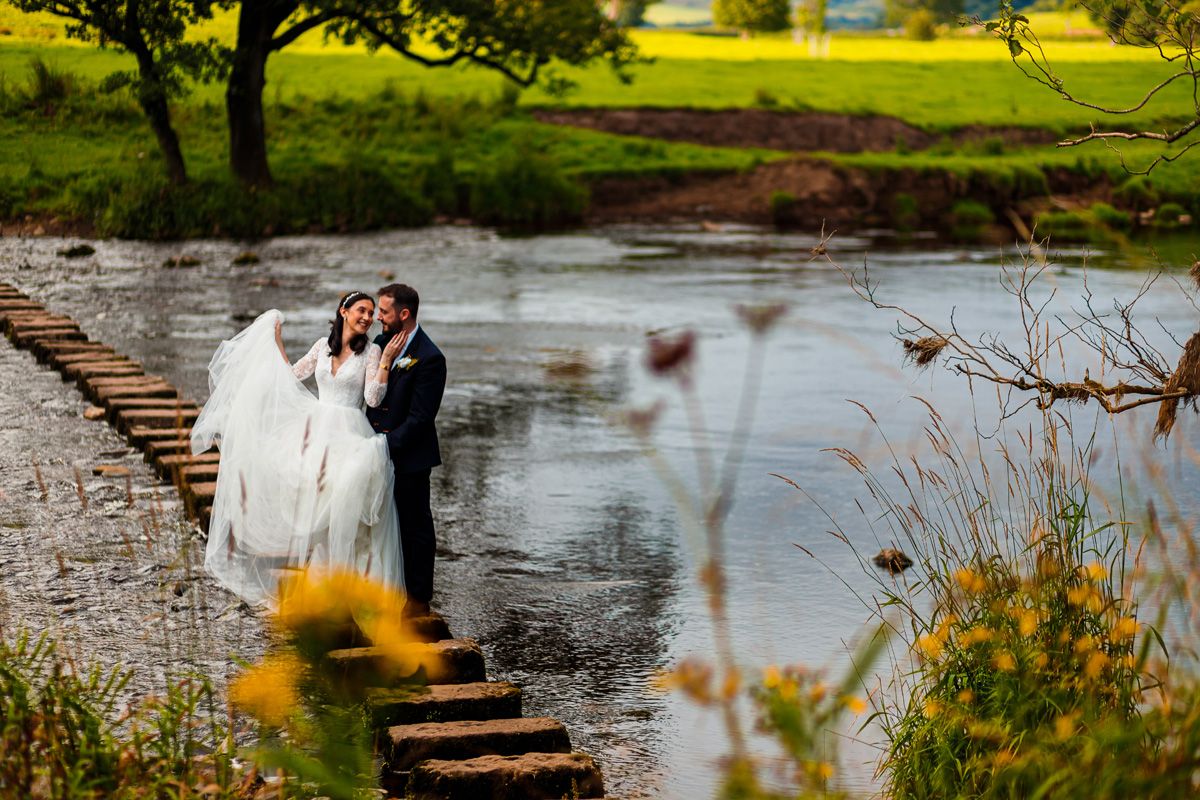 The iconic photo for the Inn at Whitewell. Aaron & Jade brave the stepping stones during their portrait session.