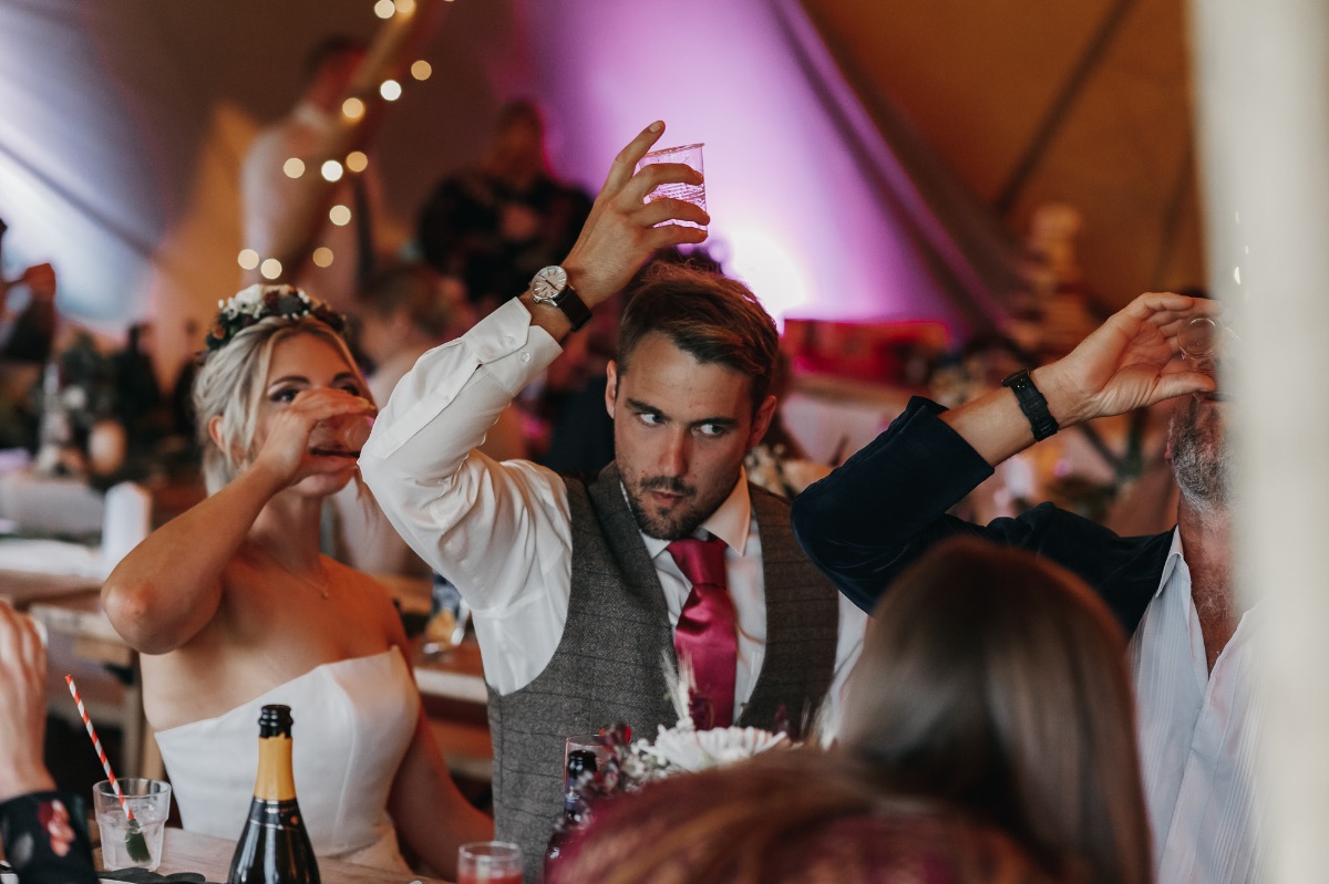 Bride and groom sharing a drink with guests