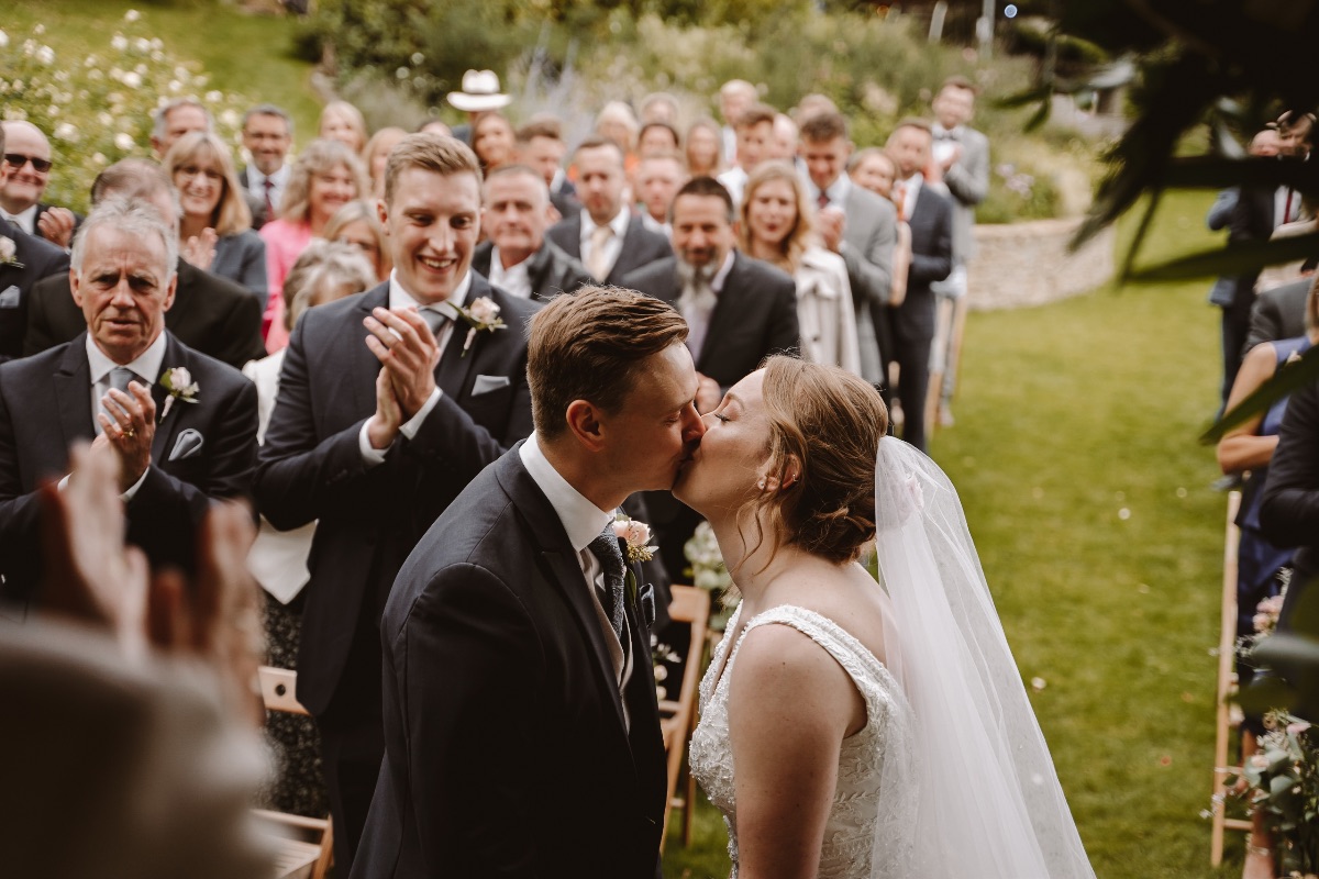 Bride and groom share a kiss to end the ceremony