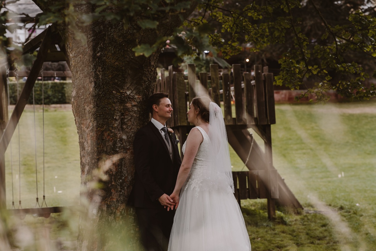 Bride stares lovingly into her grooms eyes while holding hands