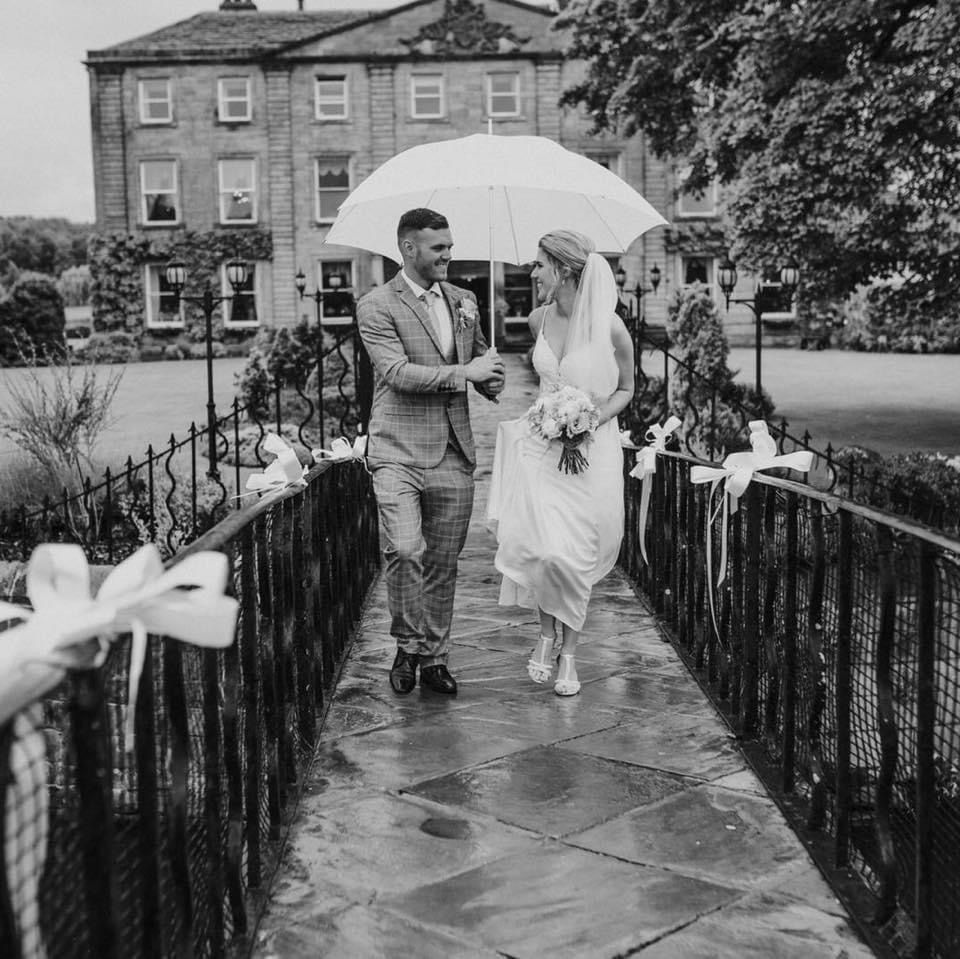 The bride and groom walking down the bridge from the private island