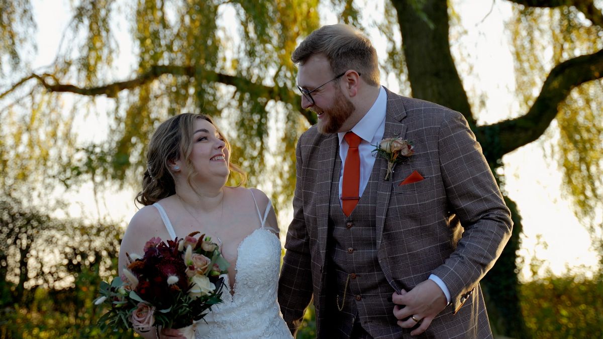 Bride and groom laughing during portrait session at Hanbury Wedding Barn