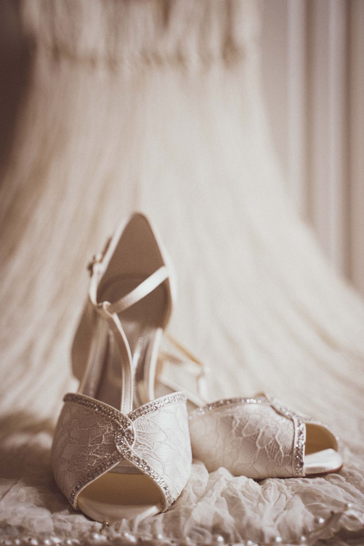 Detail shot of wedding shoes with Brides gown