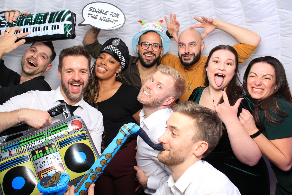 A large group of guests enjoying the ample room in the igloo booth