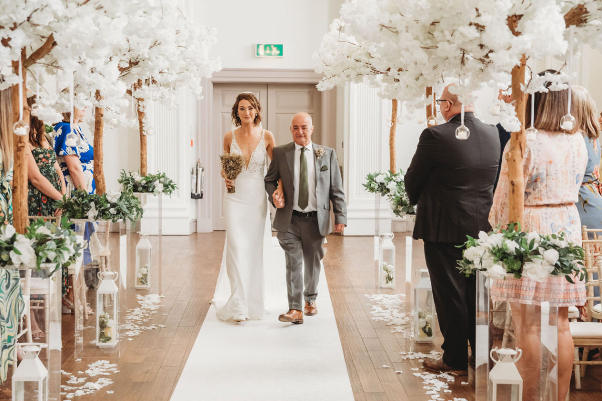 Sophie with her dad walking down the aisle