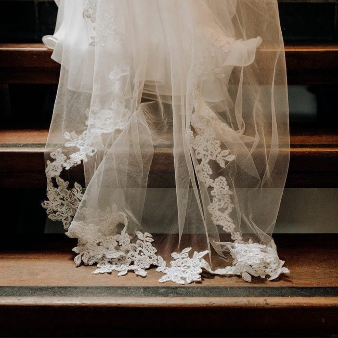 Brides veil going up the stairs