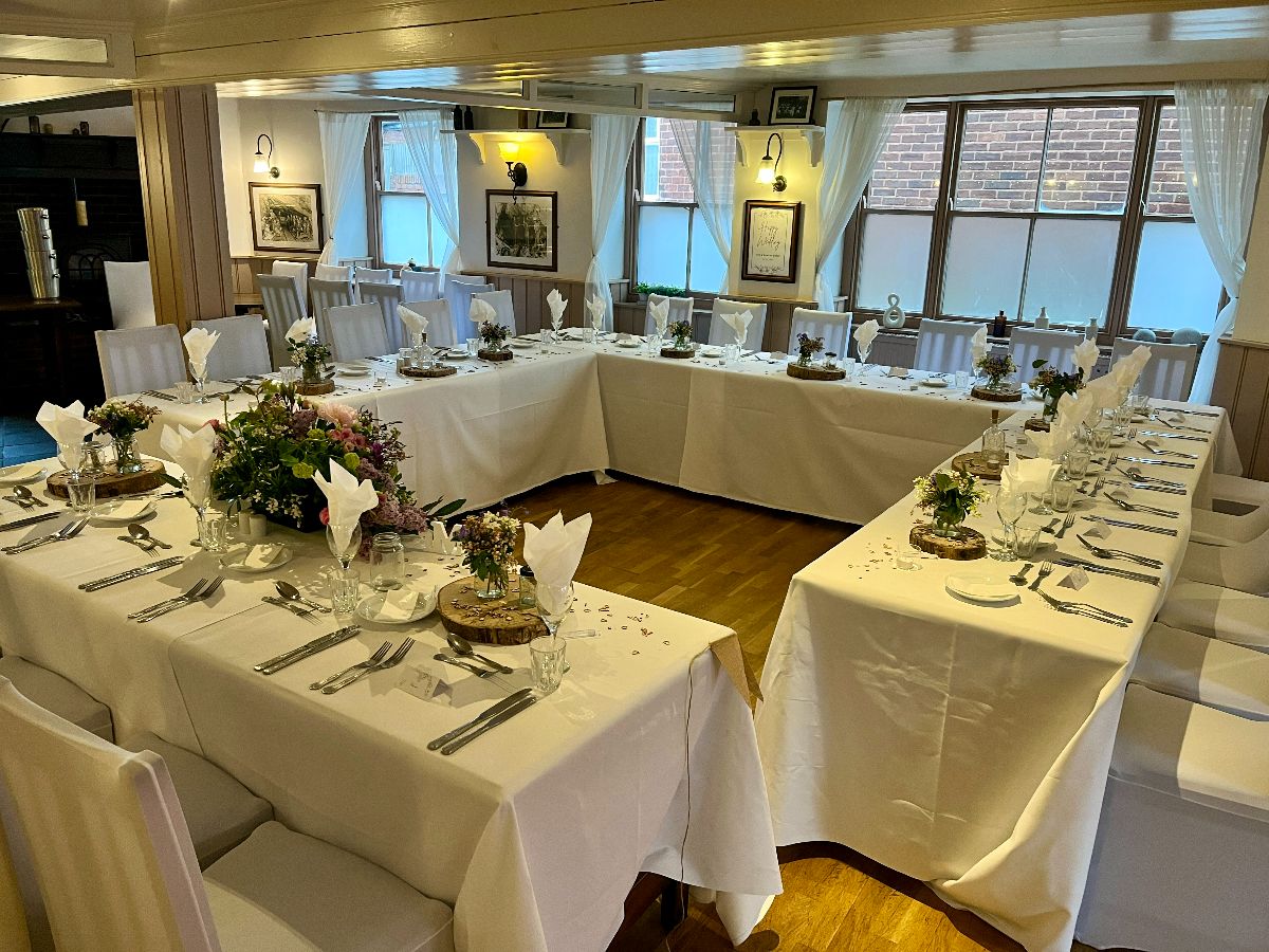 Beautiful traditional tablecloths and personal table decor, creating a setting that's simple yet elegantly timeless.
